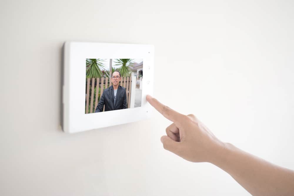 Wall mounted screen showing person